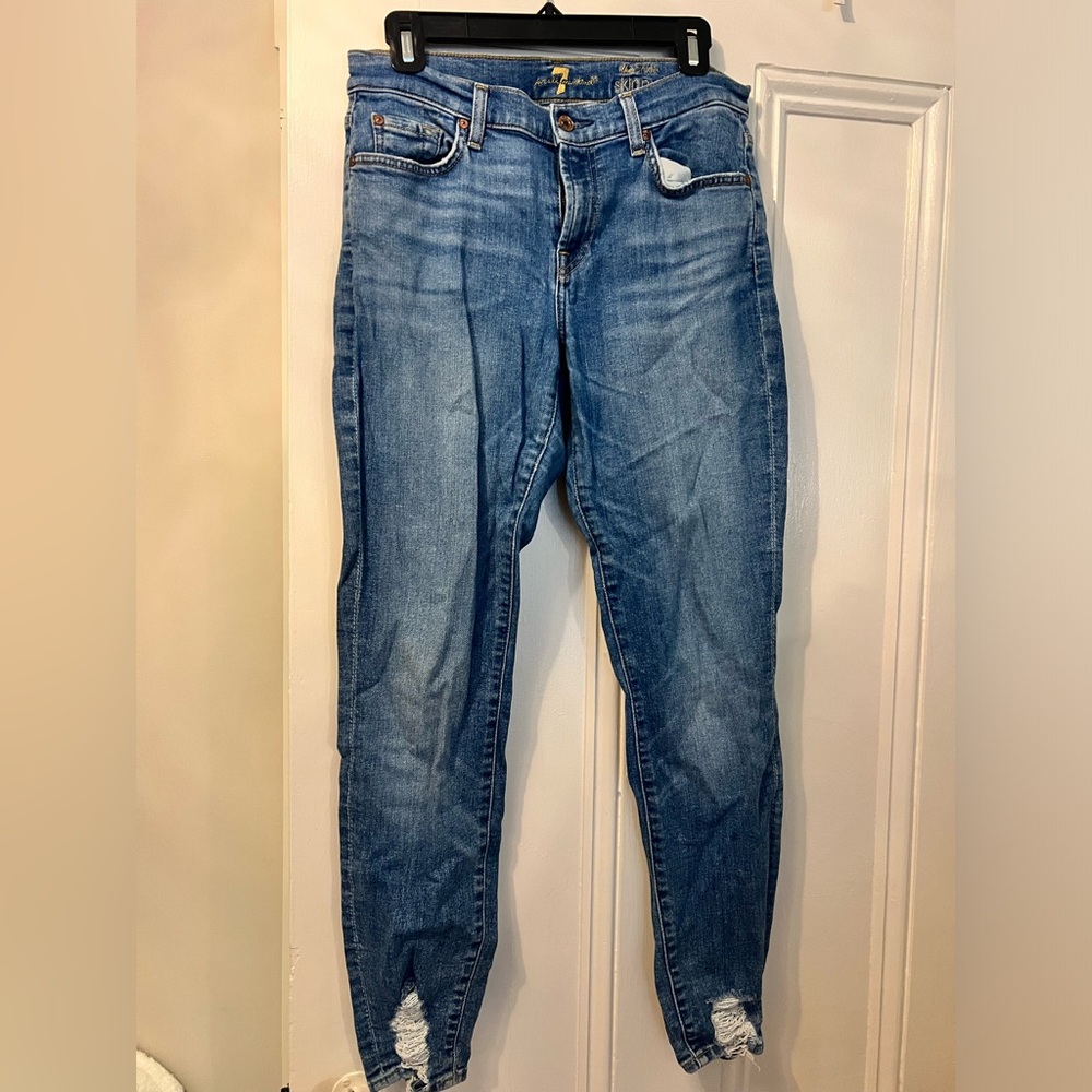 Blue skinny jeans with pre distressed ankles
